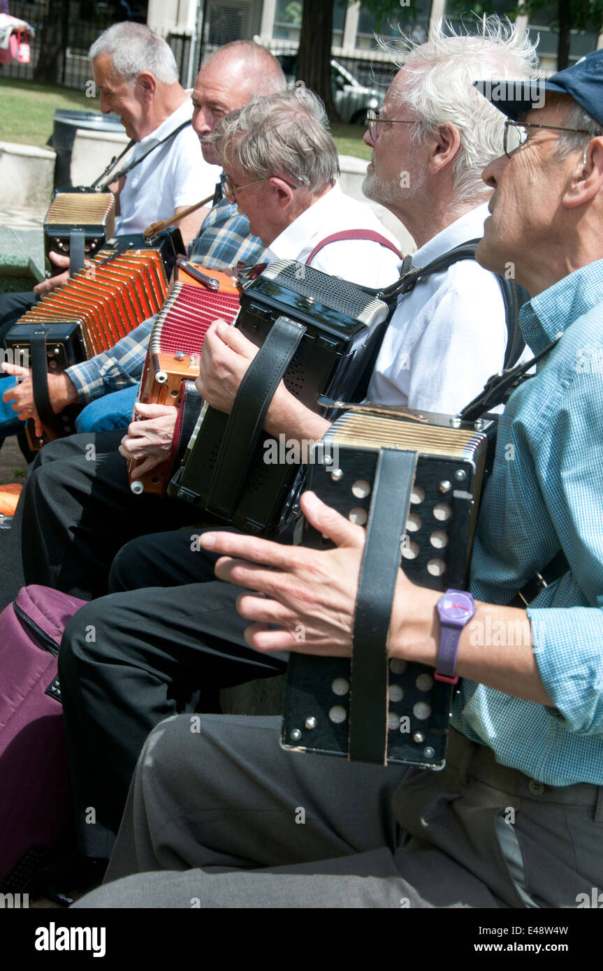 Members of the Yardarm folk orchestra play melodeons and accordion in Altab Ali Park, Whitechapel, before the march. Stock Photo