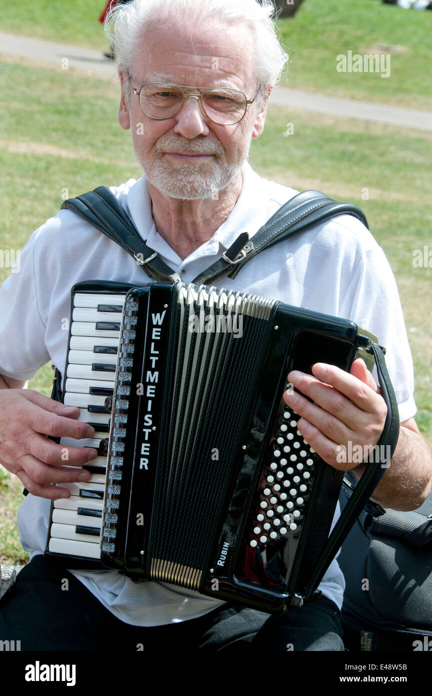 A members of the Yardarm folk orchestra plays an accordian in Altab Ali Park, Whitechapel, before the march. Stock Photo