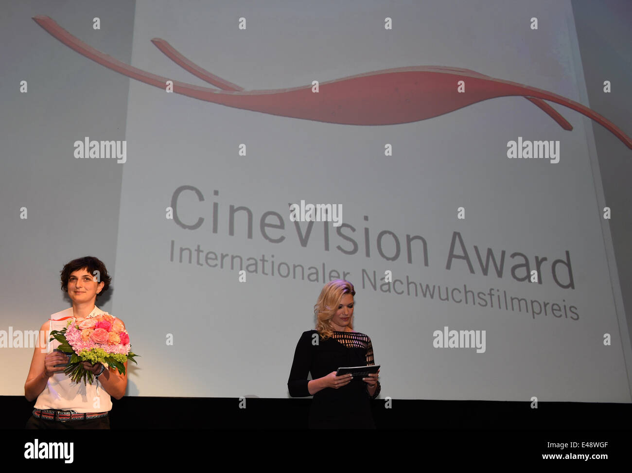 Munich, Germany. 5th July, 2014. Winner of the CineVision Awards Italian directress Alice Rohrwacher (L) at the final event of the Munich international film festival in Munich, Germany, 5 July 2014. Hostess Jessica Kastrop stands next to her. Photo: Felix Hoerhager/dpa/Alamy Live News Stock Photo