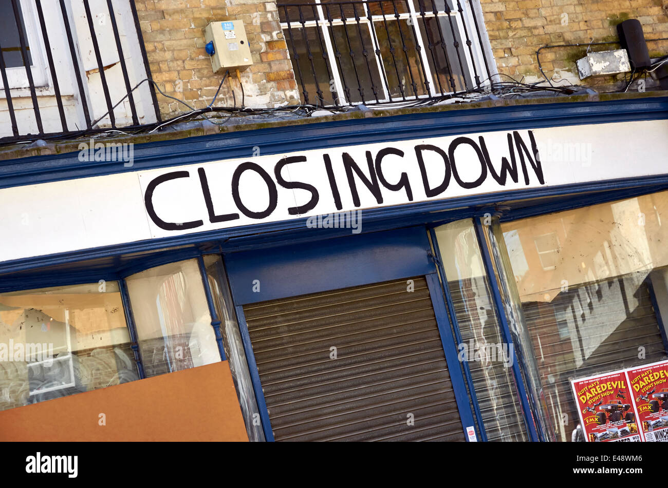 Closed down shop still displaying ' closing down' sign in the High