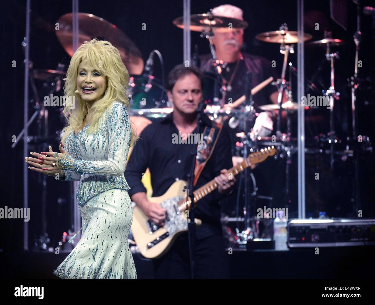 Cologne, Germany. 5th July, 2014. US singer Dolly Parton (L) stands next to her guitarist as she performs at the Lanxess Arena concert venue in Cologne, Germany, 5 July 2014. Parton is also going to perform a concert in Berlin during her current Blue Smoke World Tour on 6 July 2014. Photo: Henning Kaiser/dpa/Alamy Live News Stock Photo