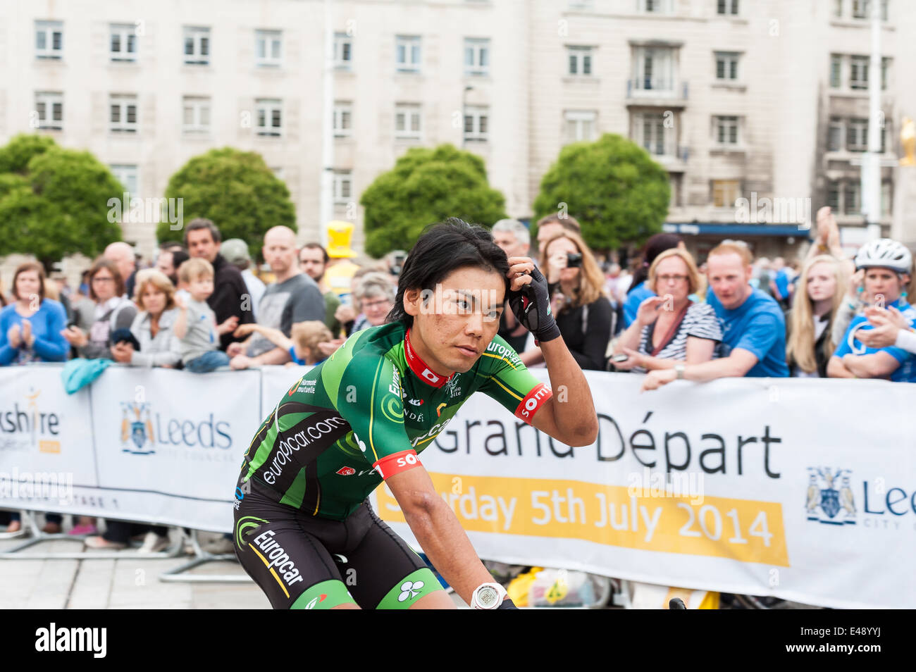 Yukiya Arashiro of team Europcar rides through Millennium Square in Leeds heading to the Tour de France opening ceremony Stock Photo
