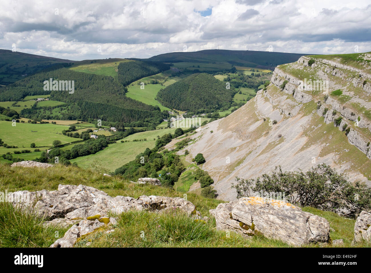 Eglwyseg mountain limestone escarpment above green valley near Llangollen, Denbighshire, North Wales, UK, Britain Stock Photo