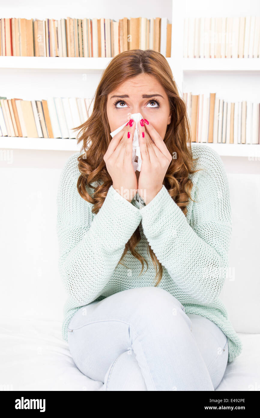 sick woman caught cold blowing her nose into handkerchief having flu or allergy Stock Photo