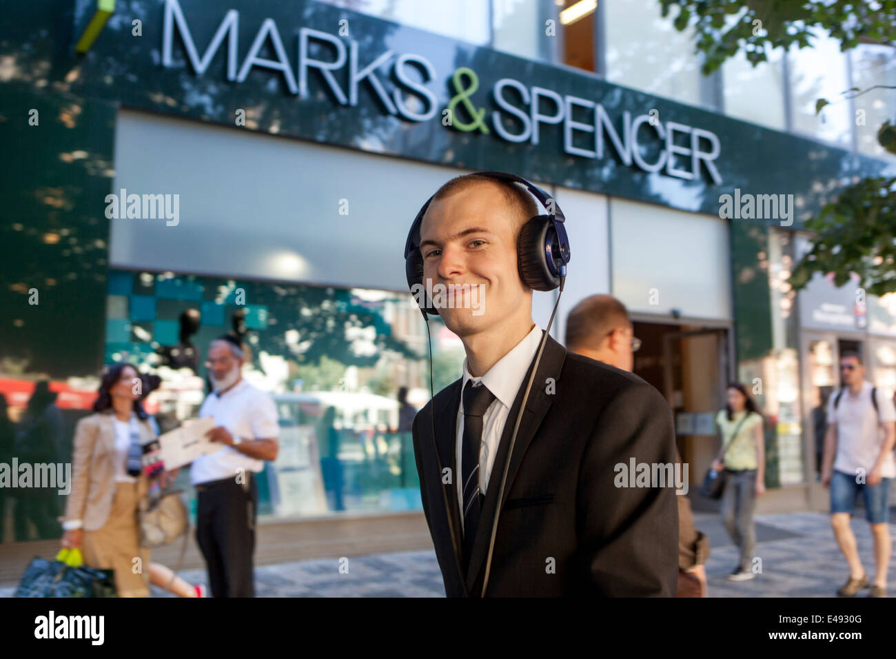 Man with headphones, Marks & Spencer Wenceslas Square Prague, Czech Republic Stock Photo