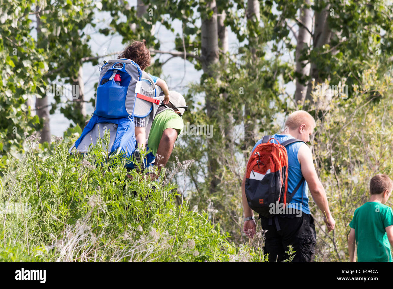 Two fathers and two sons hiking in the Leslie St Spit or Tommy Tompson Park in Toronto Ontario Stock Photo