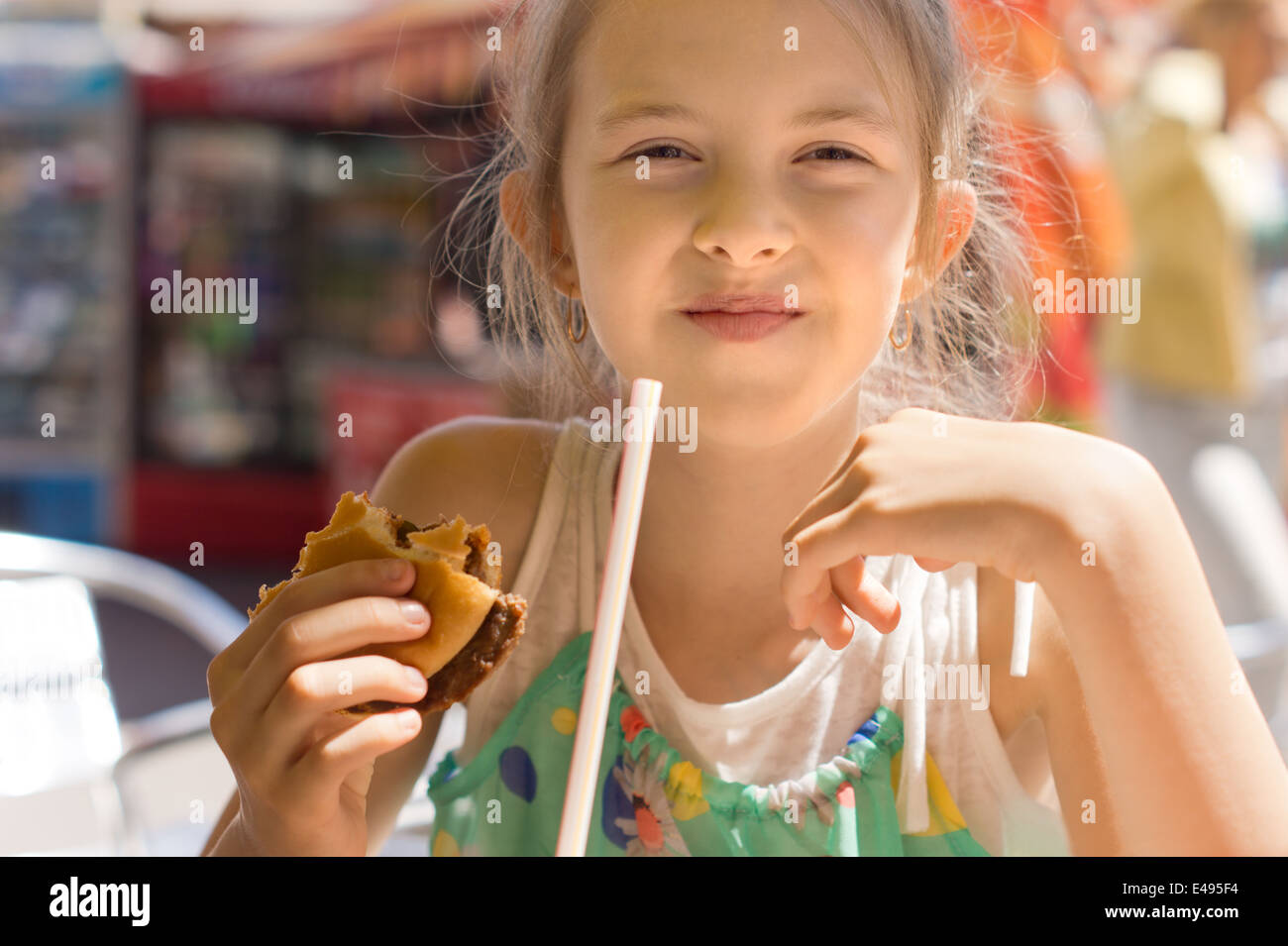 Girl having the lunch at a fast-food restaurant Stock Photo