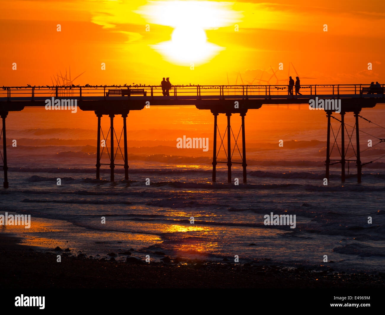 People watching the sunset from Saltburn Pier Stock Photo