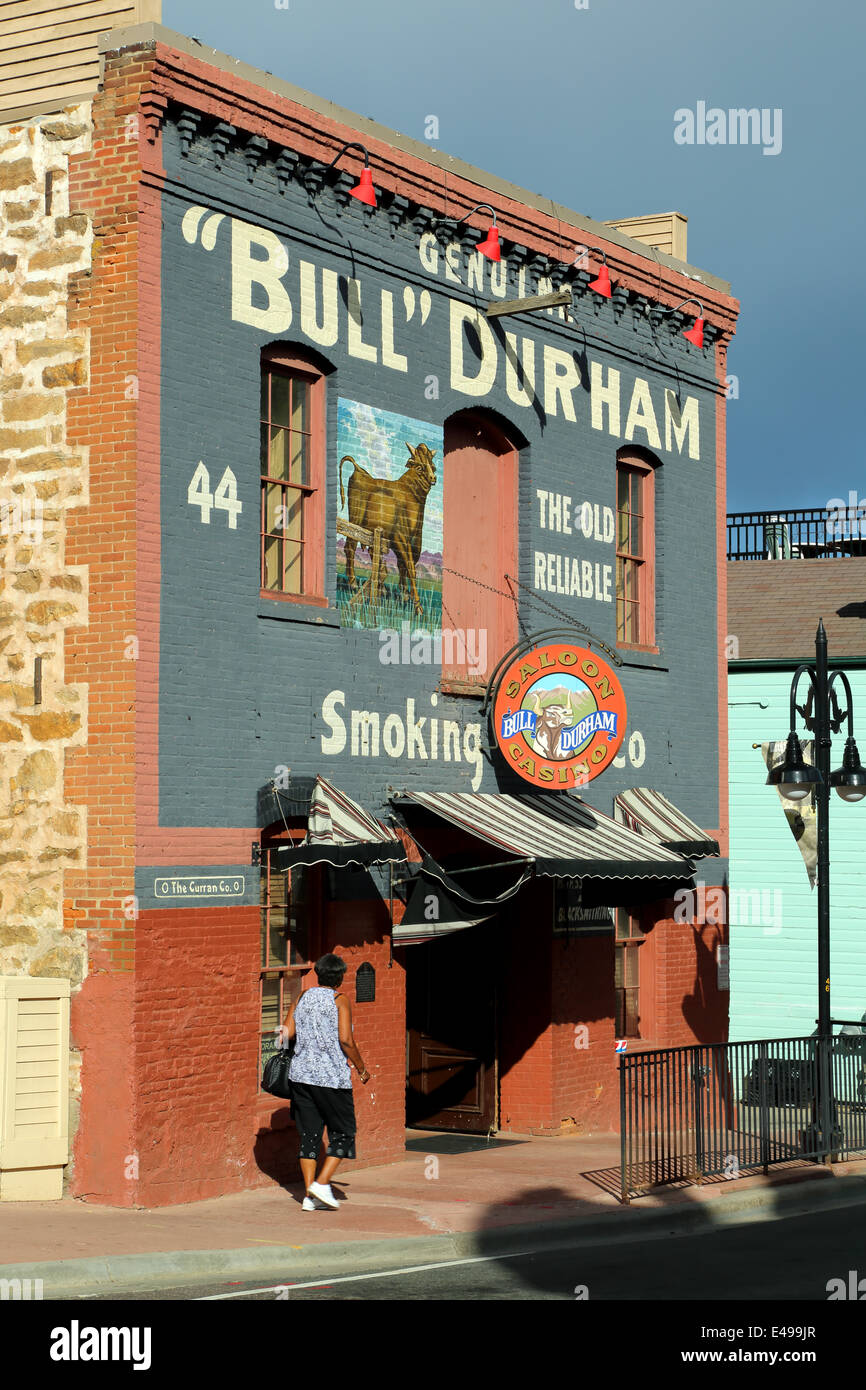 Woman walking by Bull Durham Saloon and Casino, historic Main Street, Black Hawk, Colorado USA Stock Photo