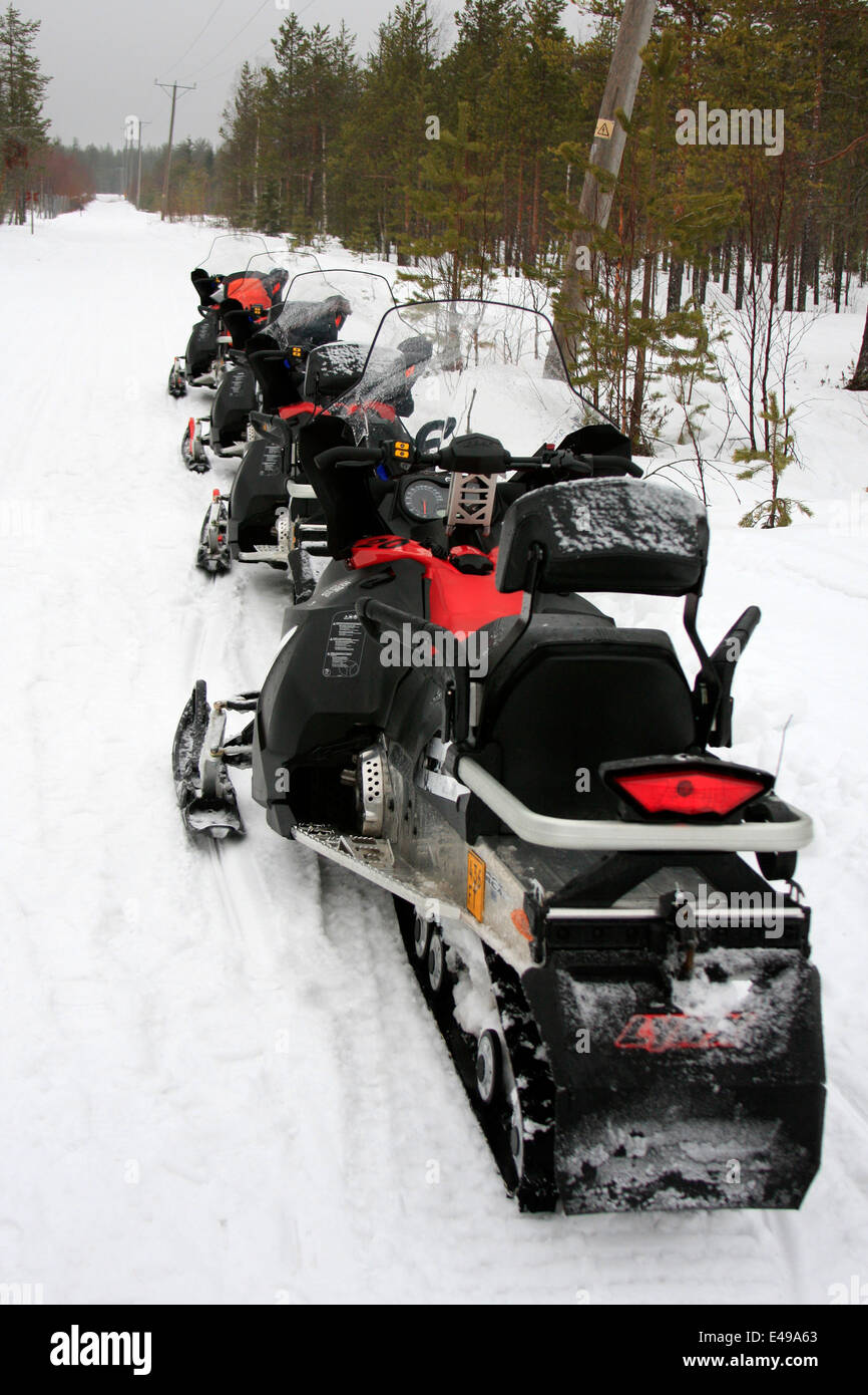 Snowmobiles in woods near Rovaniemi in Lapland, Finland Stock Photo