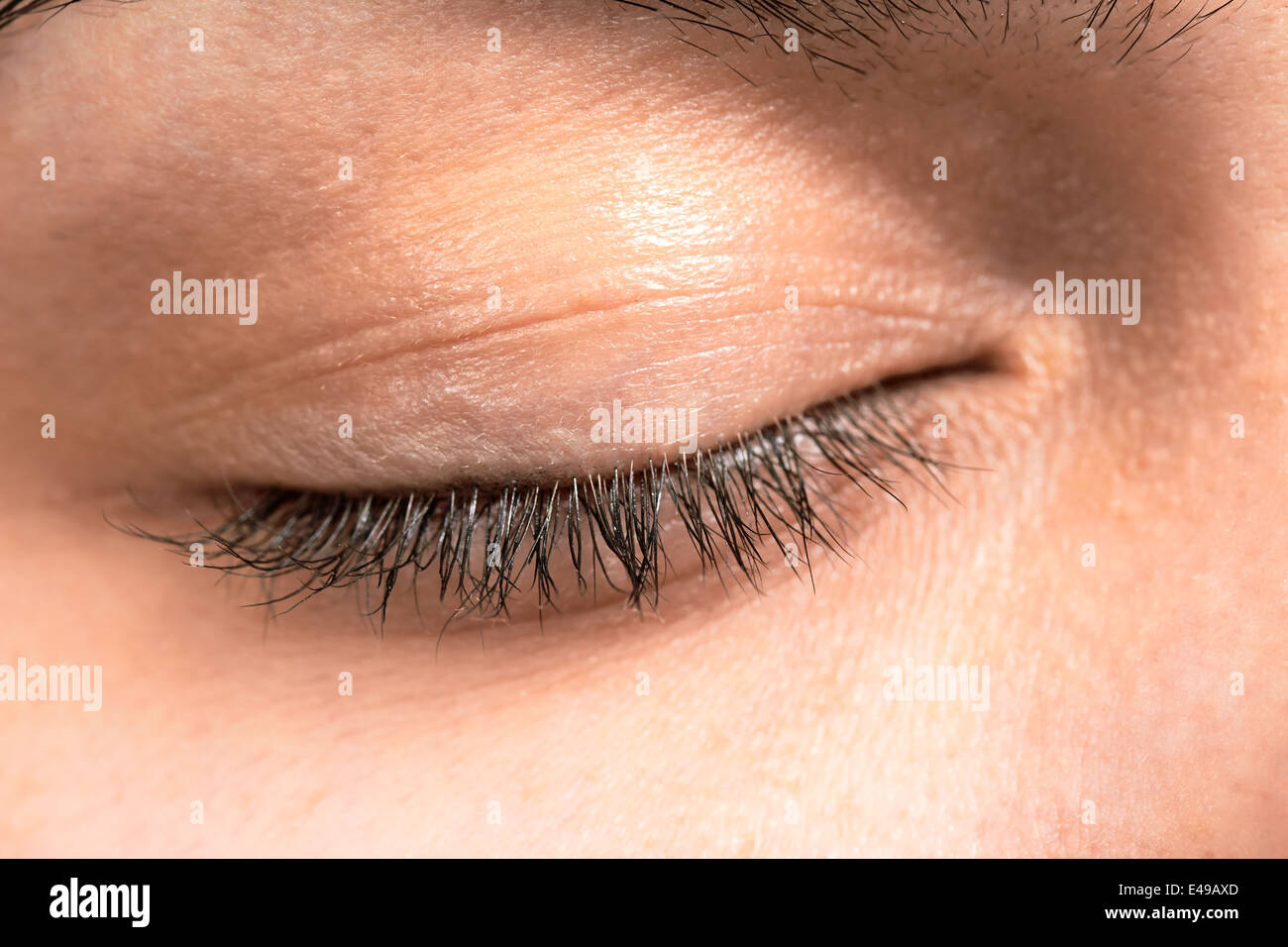 Closed female eye lashes closeup Stock Photo