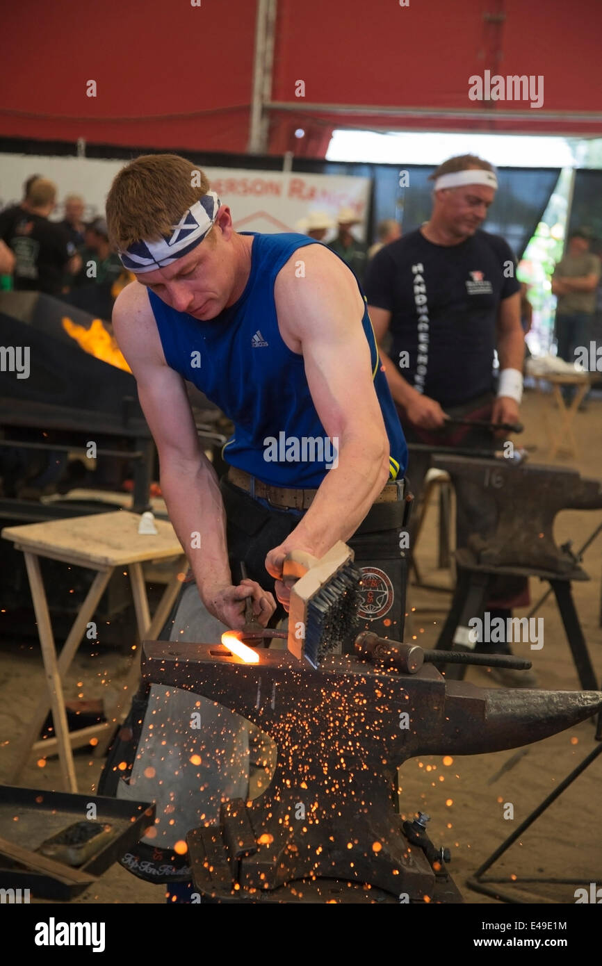 Calgary, Alberta, Canada. 06th July, 2014. Farrier prepares hot horse shoe on anvil while competing in the final round of the World Championships Blacksmiths' competition at the Calgary Stampede on Sunday, July 6, 2014. The top five farriers are competing for the title of world champion in this longstanding tradition at the Stampede. Calgary, Alberta, Canada. Credit:  Rosanne Tackaberry/Alamy Live News Stock Photo