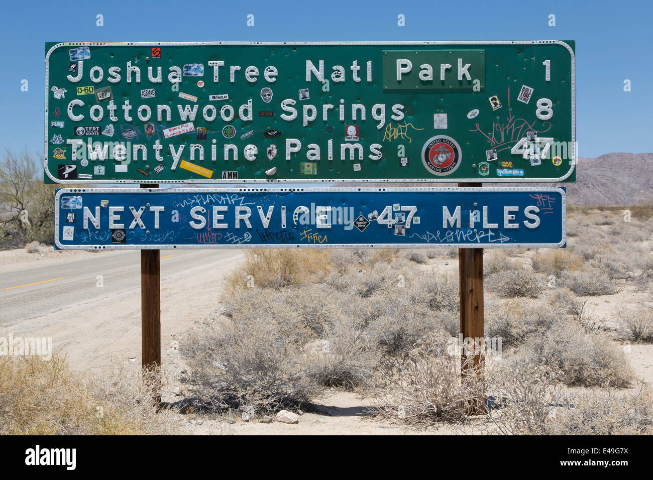 Road sign for Joshua Tree National Park, California with many stickers attached Stock Photo