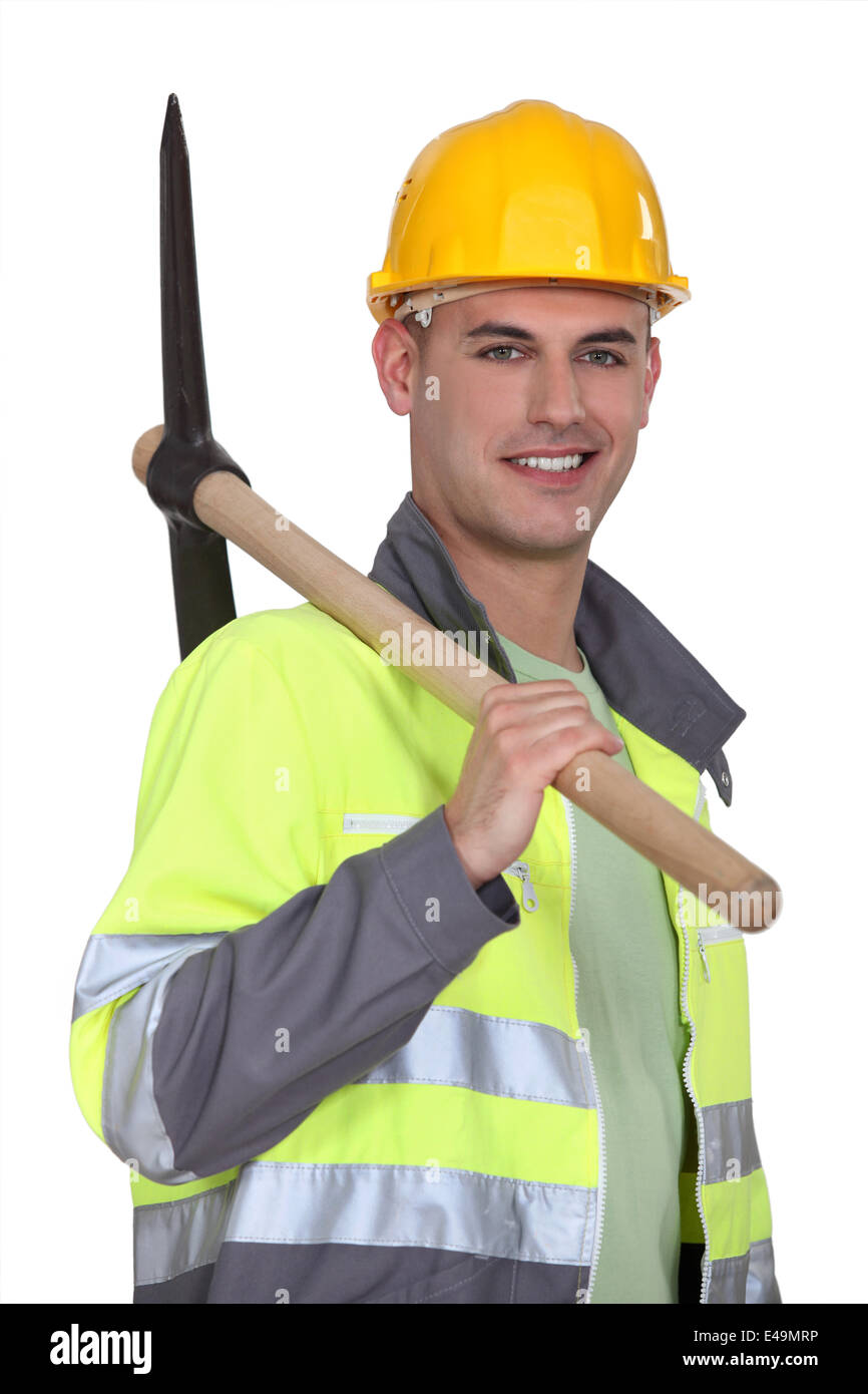 Tradesman carrying a pickaxe Stock Photo
