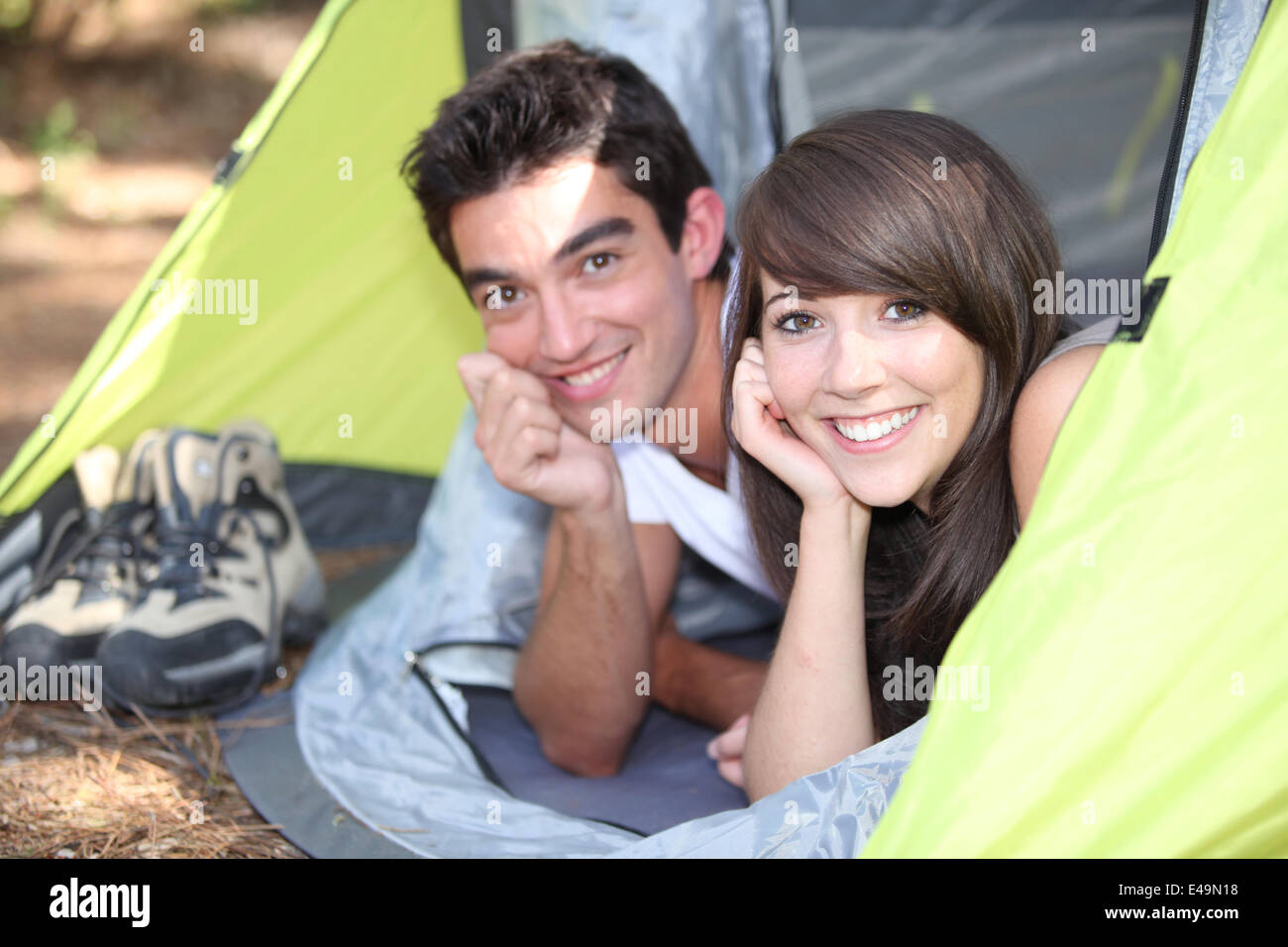 Young couple lying in a tent Stock Photo