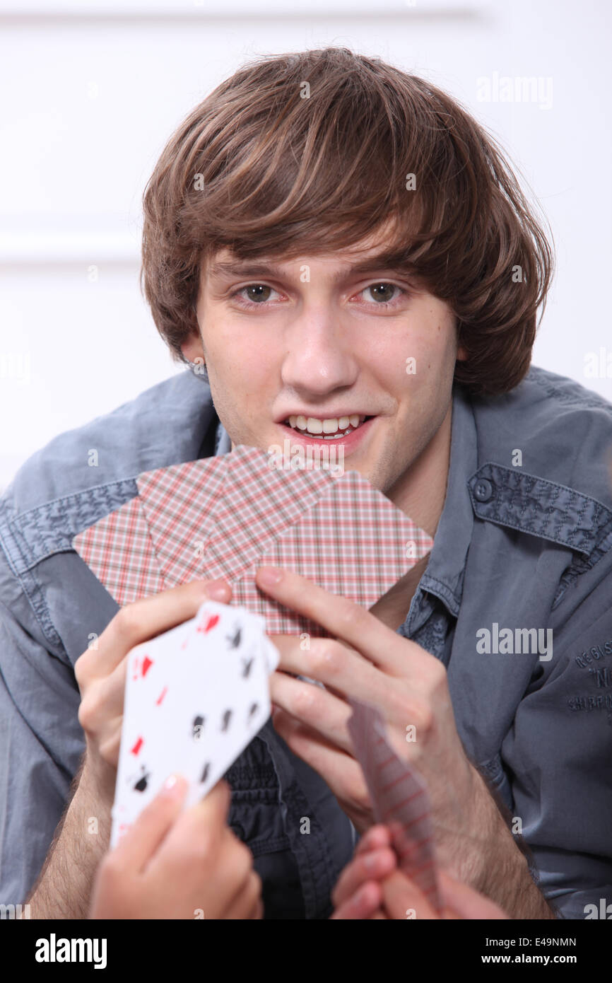 Teenage boy playing cards Stock Photo Alamy