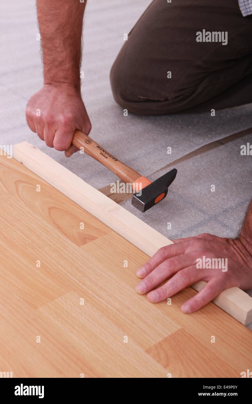 handyman laying floorboards Stock Photo Alamy