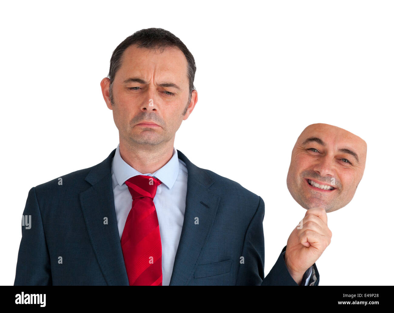 sad businessman concealing depression with a happy mask isolated on a white background Stock Photo