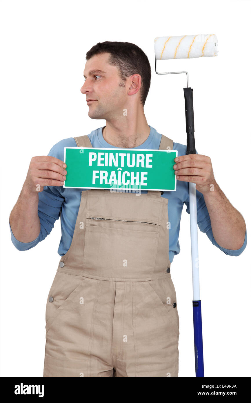 Man with a French wet paint sign Stock Photo