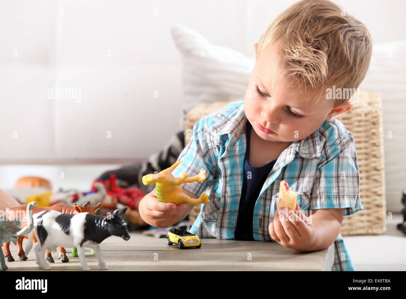 Little boy playing with toys Stock Photo - Alamy