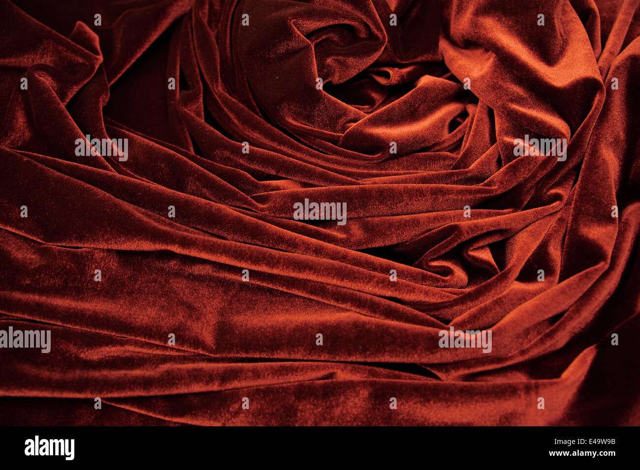 dark red glossy velvet is formative folds Stock Photo