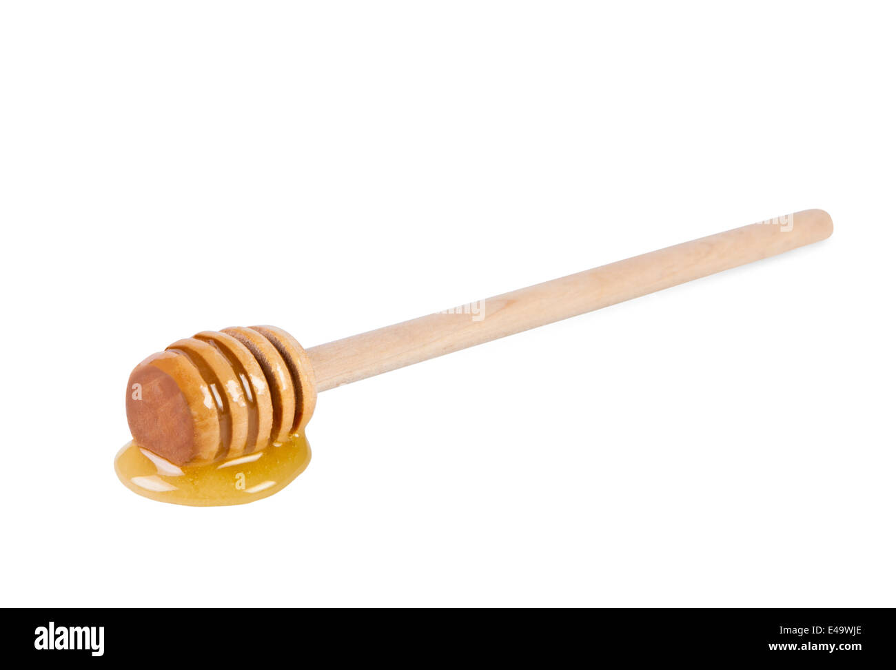 Wooden stick with honey on white background. Stock Photo