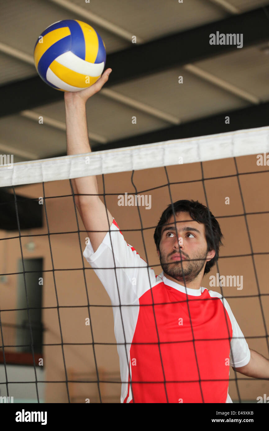 Volleyball player pushing ball over net Stock Photo Alamy