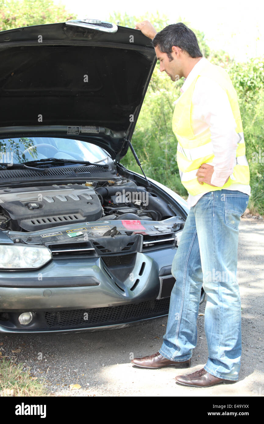 Man looking under car Stock Photo Alamy