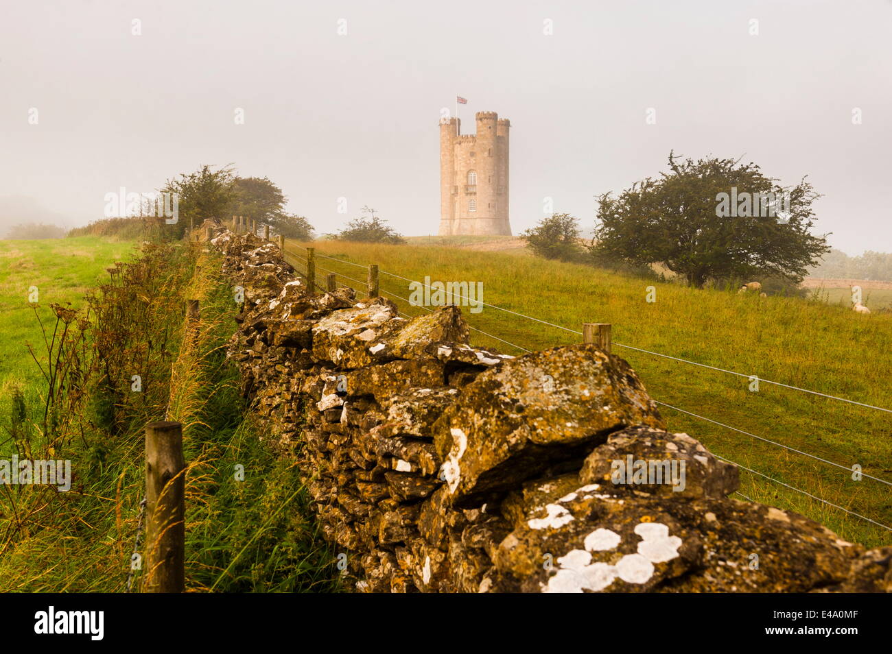 Misty sunrise at Broadway Tower, a National Trust property at Broadway, The Cotswolds, Gloucestershire, England, United Kingdom Stock Photo