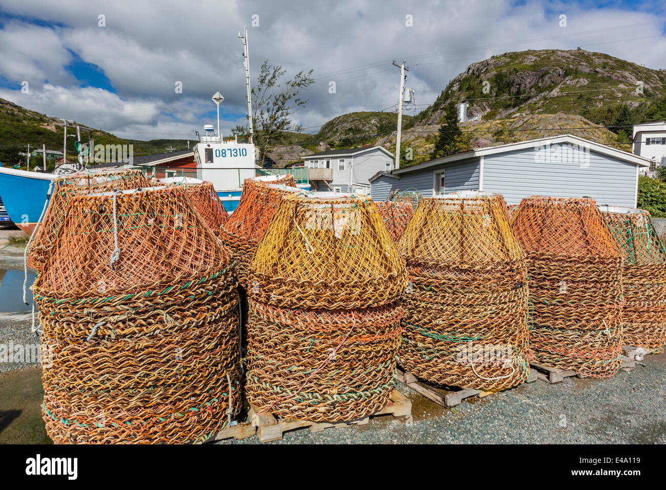 Lobster traps near fishing boat outside St. John's, Newfoundland, Canada, North America Stock Photo