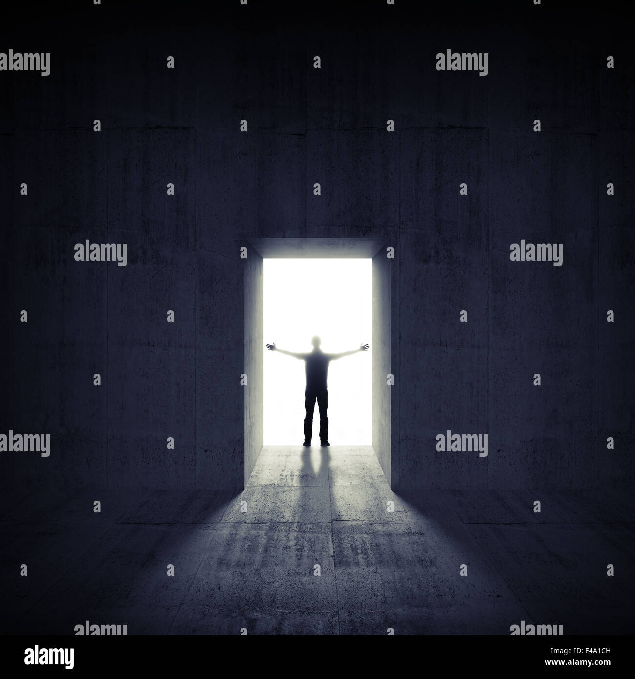 Abstract dark concrete interior with glowing door and man silhouette Stock Photo
