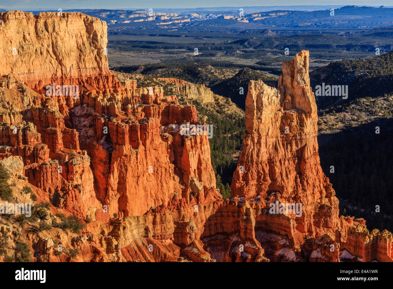 Hoodoos lit by late afternoon sun with distant view in winter, Paria View, Bryce Canyon National Park, Utah, USA Stock Photo