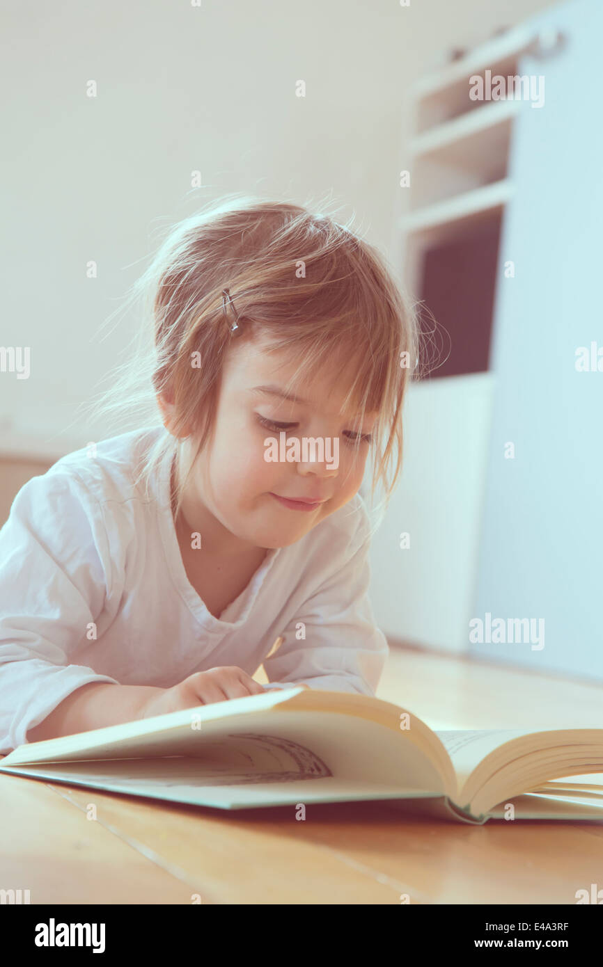 Portrait of little girl with book Stock Photo - Alamy