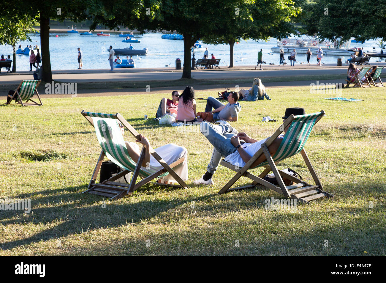 People On deck Chairs Hyde Park London UK Stock Photo