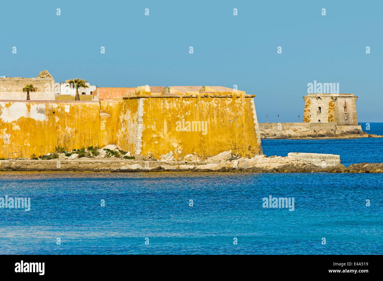 Old city walls and Tower of Ligny, now a Museum of Prehistory, on sea front of northwest fishing port, Trapani, Sicily, Italy Stock Photo