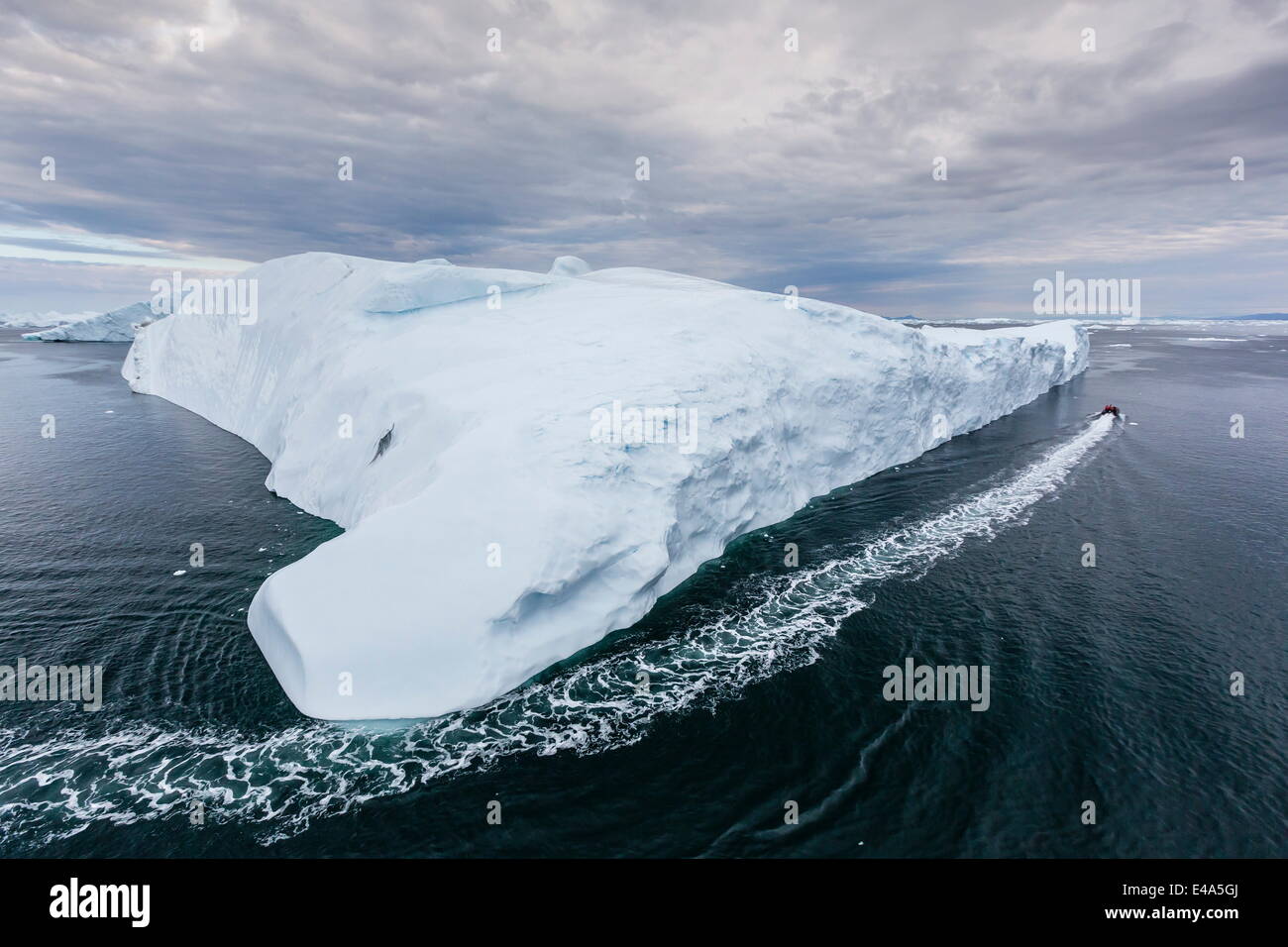 A Zodiac amongst huge icebergs calved from the Ilulissat Glacier, UNESCO, Ilulissat, Greenland, Polar Regions Stock Photo