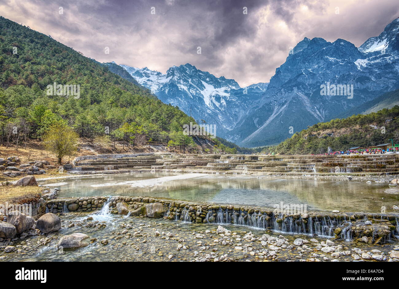 HDR image of cascading falls at Baishuihe, or White Water River with Jade Dragon Snow Mountain, Lijiang, Yunnan, China, Asia Stock Photo