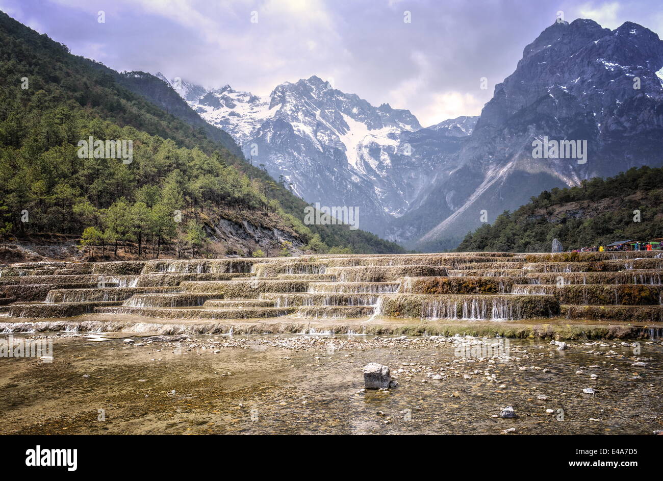 Cascading falls at Baishuihe with Jade Dragon Snow Mountain backdrop, Lijiang, Yunnan, China, Asia Stock Photo