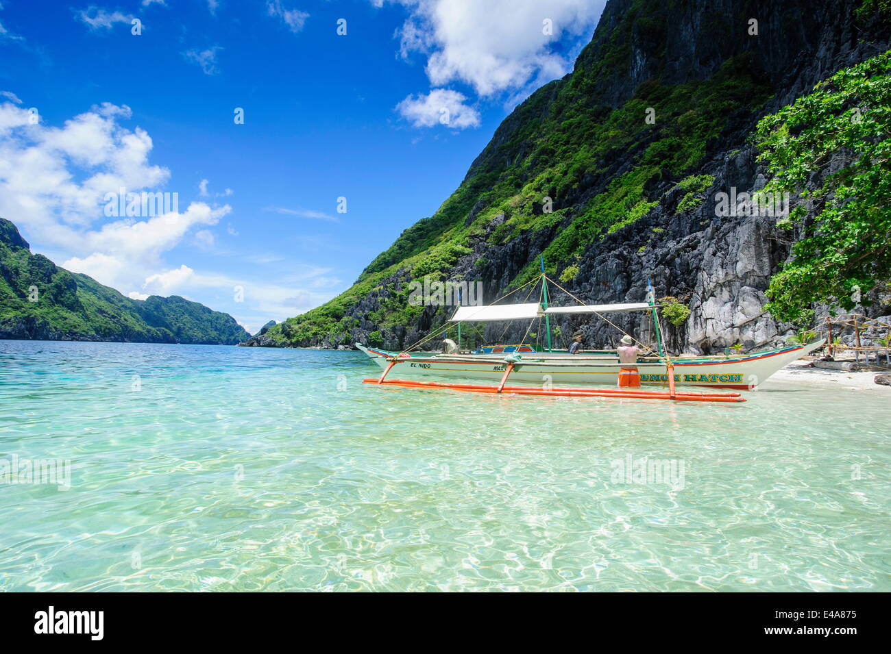Outrigger boat in the crystal clear water in the Bacuit archipelago, Palawan, Philippines, Southeast Asia, Asia Stock Photo