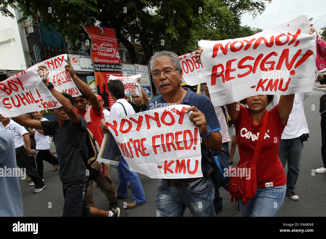 Manila, Philippines. 7th July, 2014. Activists hold placards as they call for President Aquino III to step down from office during a protest rally in Manila, the Philippines, July 7, 2014. A former government official on Monday filed another impeachment complaint against Philippine President Benigno Aquino III for bribery and violation of the Philippine Constitution. Credit:  Rouelle Umali/Xinhua/Alamy Live News Stock Photo