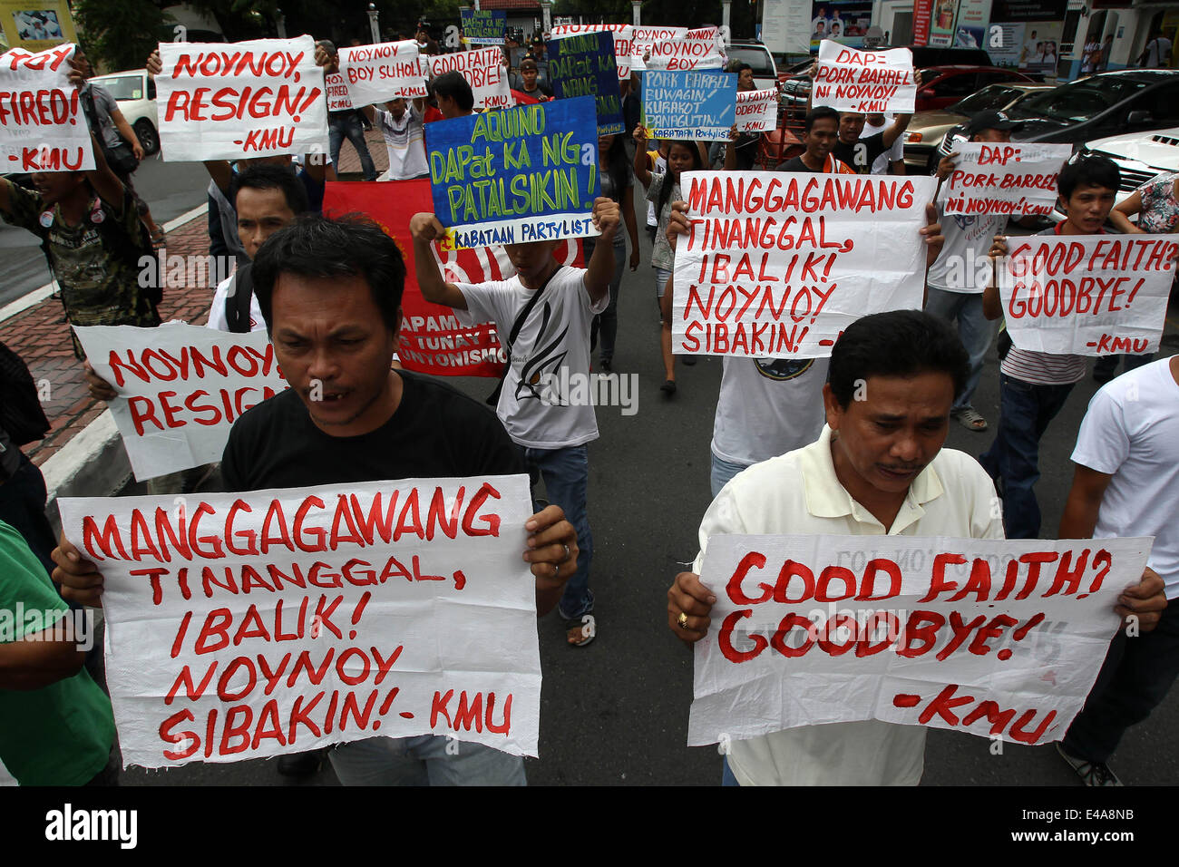 Manila, Philippines. 7th July, 2014. Activists hold placards as they call for President Aquino III to step down from office during a protest rally in Manila, the Philippines, July 7, 2014. A former government official on Monday filed another impeachment complaint against Philippine President Benigno Aquino III for bribery and violation of the Philippine Constitution. Credit:  Rouelle Umali/Xinhua/Alamy Live News Stock Photo