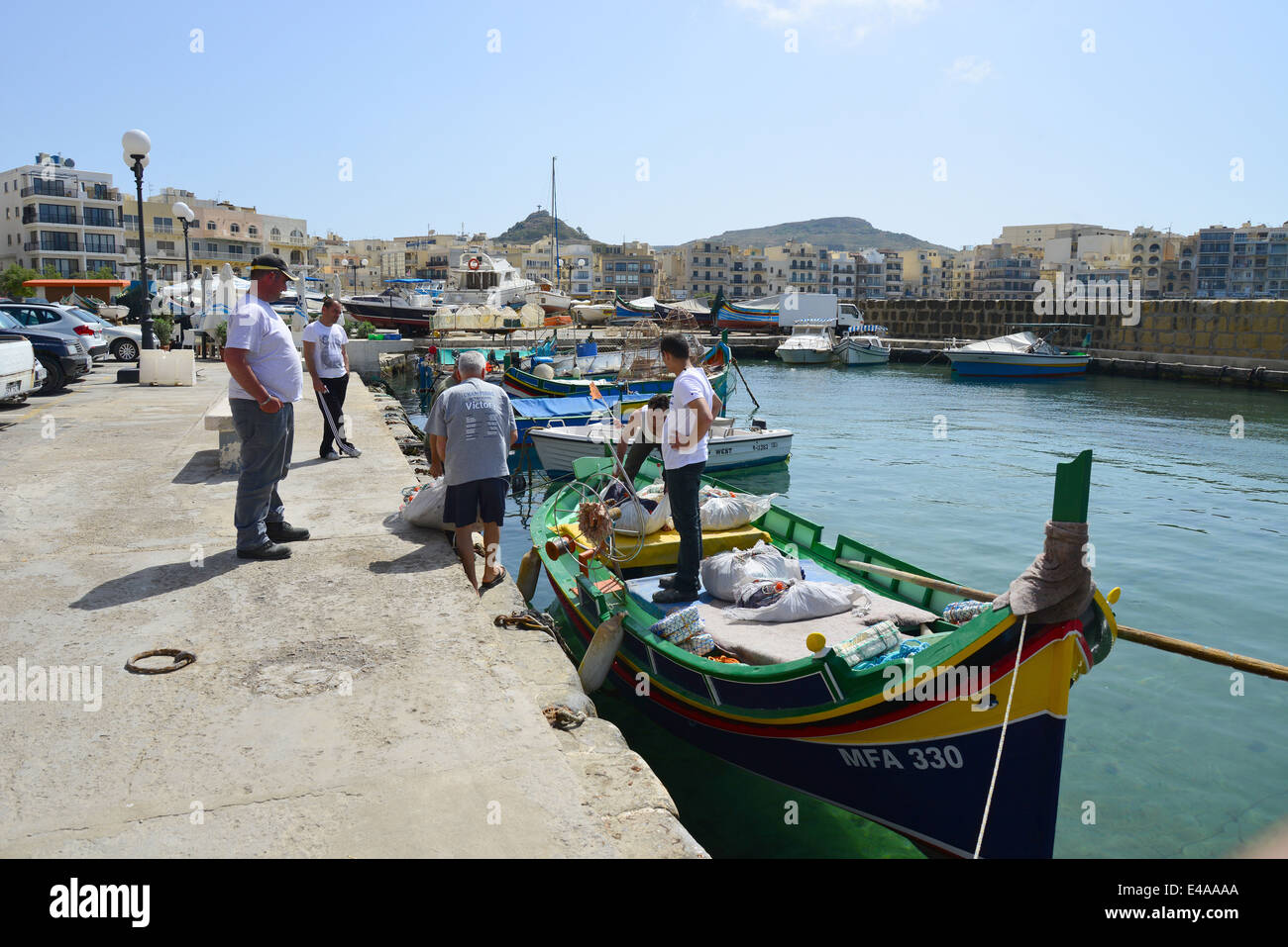 Fishermen on Luzzu boat, Marsalforn, Gozo (Għawdex), Gozo and Comino District, Gozo Region, Republic of Malta Stock Photo