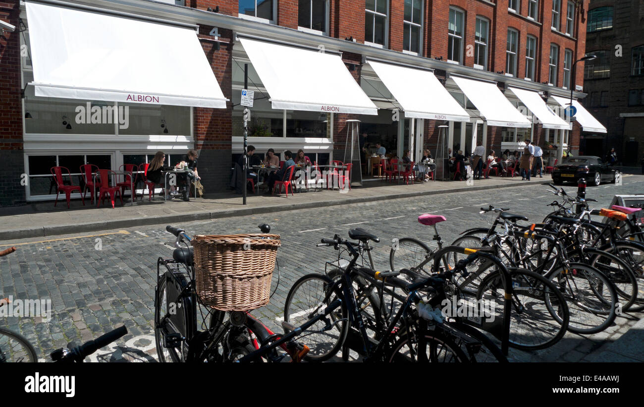 People sitting at tables outside Albion cafe bakery and food store on Boundary Street Shoreditch East London UK  KATHY DEWITT Stock Photo