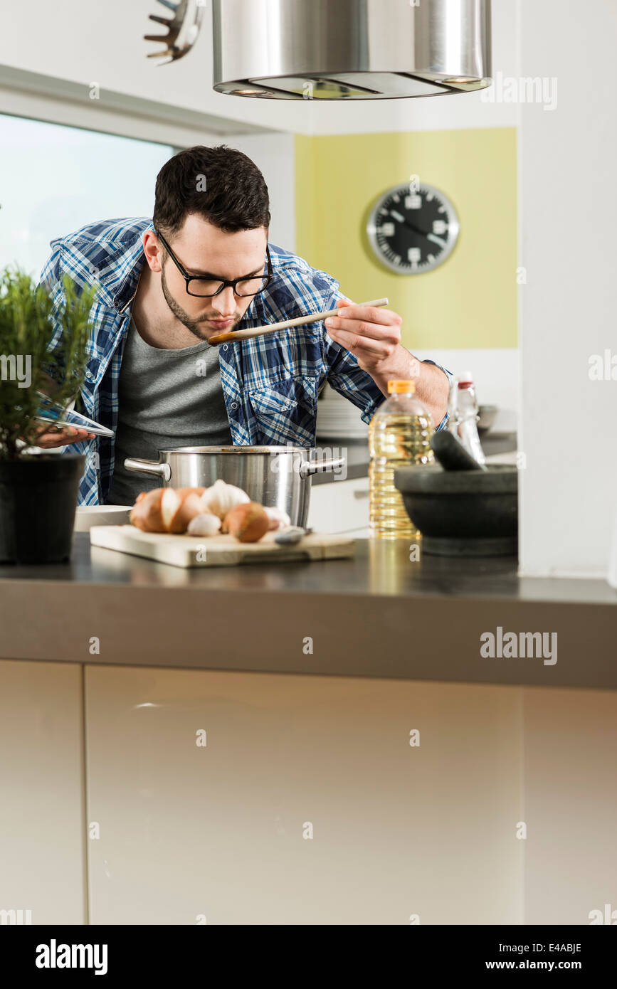 Man Cooking In Kitchen Young man cooking in kitchen at home Stock Photo - Alamy