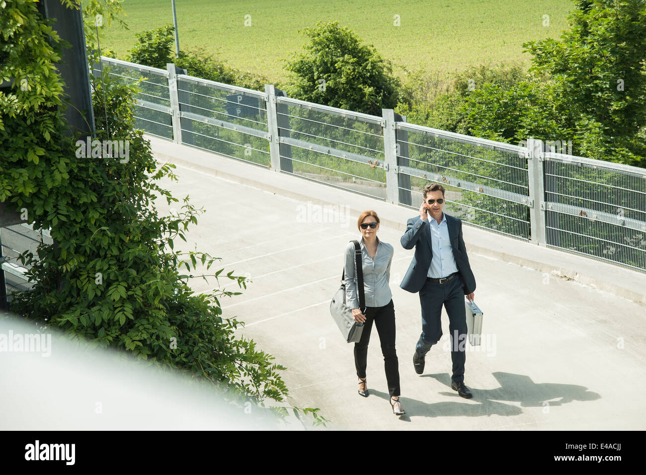 Two business people walking side by side, elevated view Stock Photo - Alamy