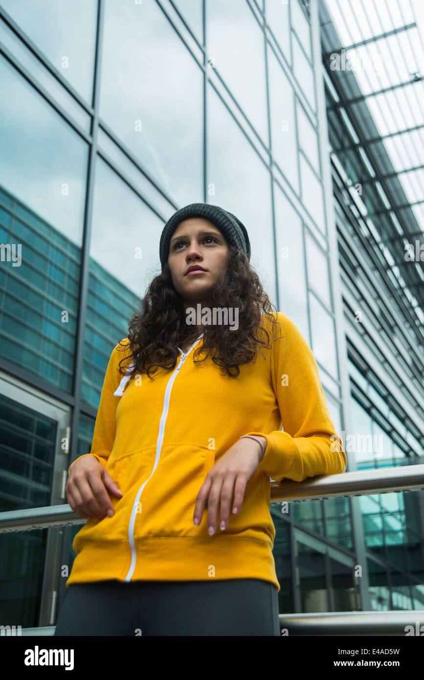 Portrait of young woman wearing yellow tracksuit top Stock Photo