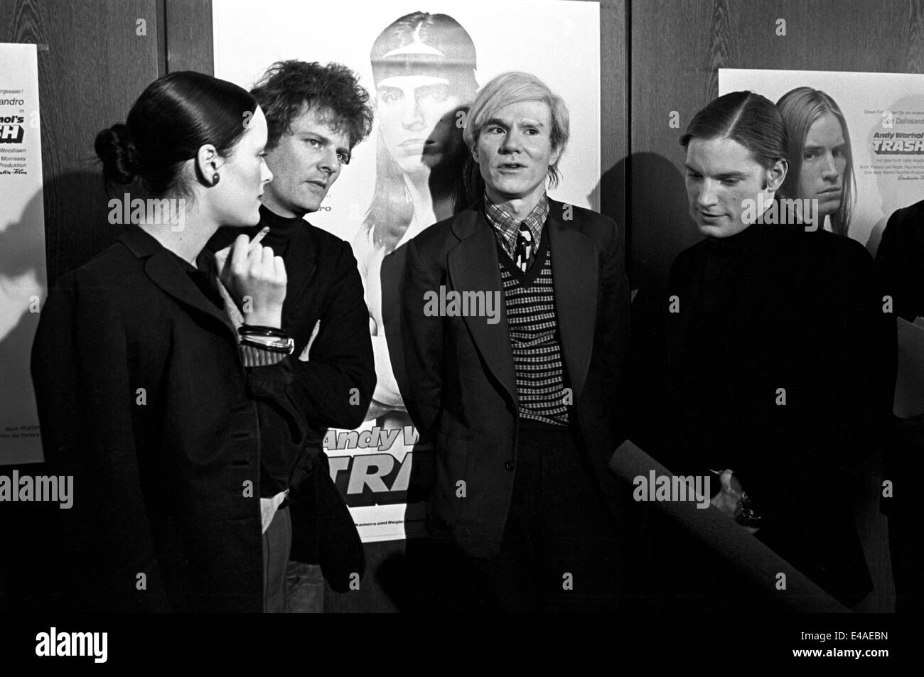 (File) The US artist and director Andy Warhol (middle) and his leading actress Jane Forth (far left) as well as Joe Dallesandro (right)  pose in Munich on 17 February 1971 before for the premiere of his latest film 'Trash'. Person 2nd to the left is not identified. Stock Photo
