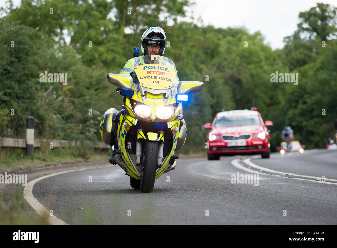 Stapleford near Cambridge, UK. 7th July, 2014.  A police motorcyclist patrols the route at Great Shelford, a village on the route from Cambridge to London. The race attracted thousands of spectators to Cambridge and the route south to Essex and London and many residents decorated their homes in a carnival atmosphere. Credit Julian Eales/Alamy Live News Stock Photo