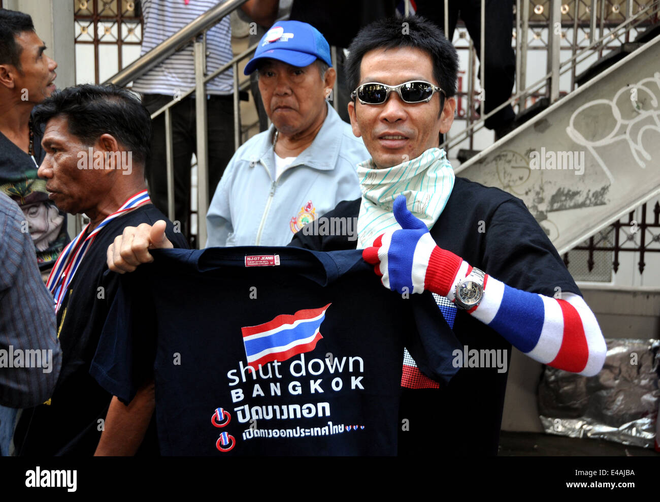 BANGKOK, THAILAND: Thai man holding up a Shut Down Bangkok tee-shirt during the anti-government protests Stock Photo