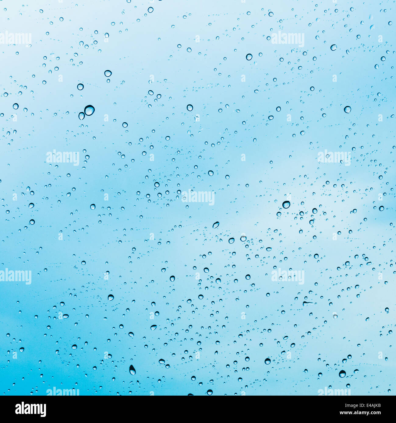 Water drops of rain on blue glass background Stock Photo - Alamy